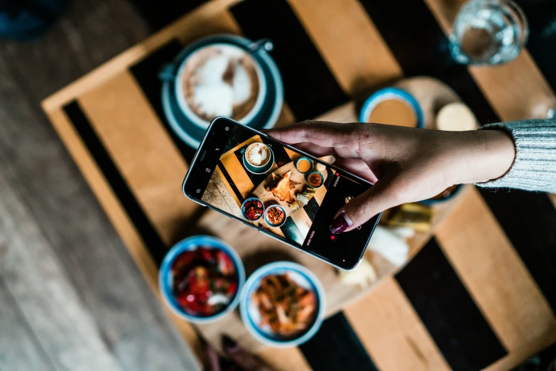 person taking a pograph of food on a table