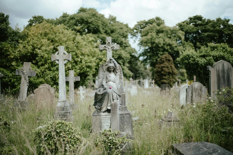 cemetery scene with a woman sitting on the grave