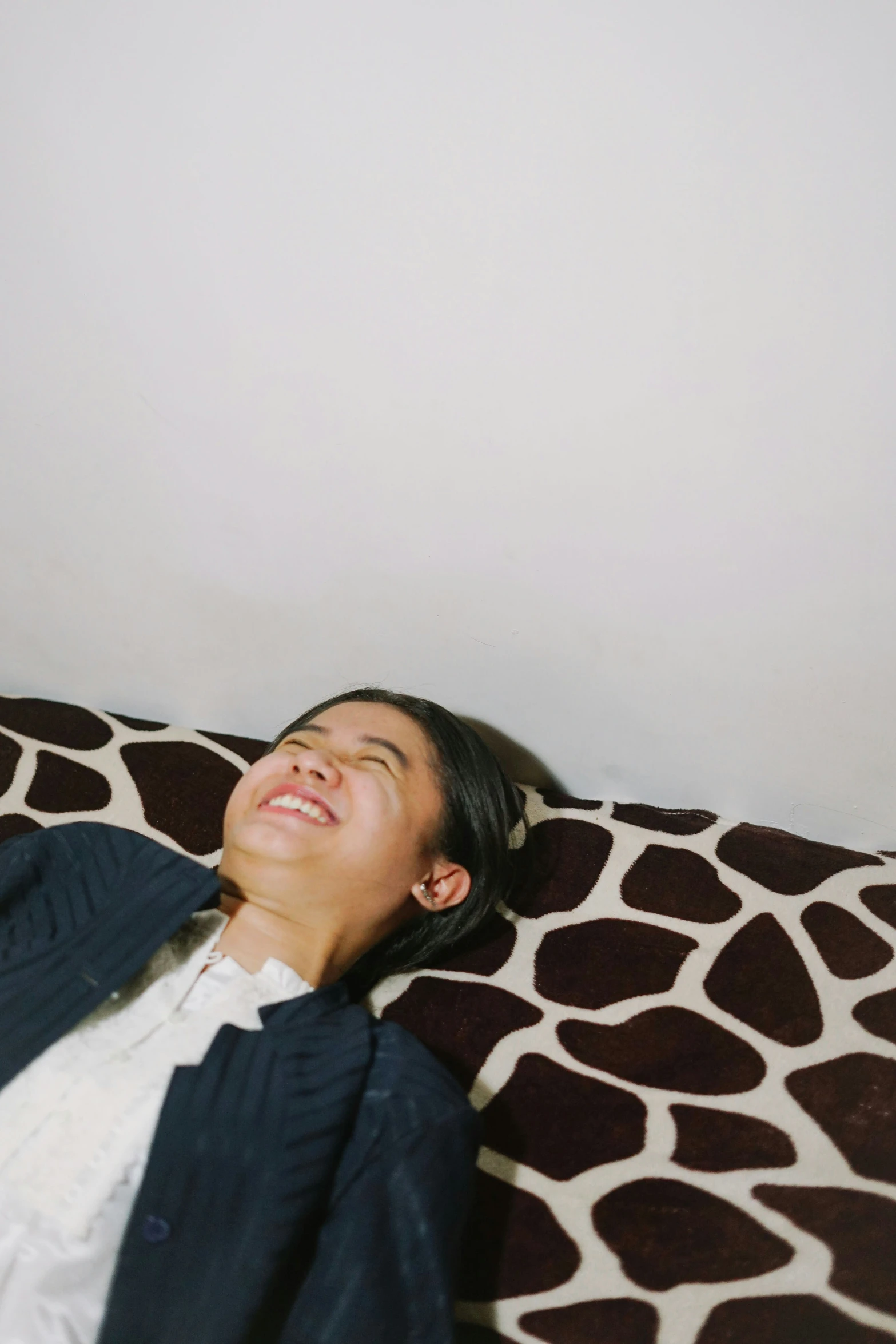 a young lady laying down on the floor looking up