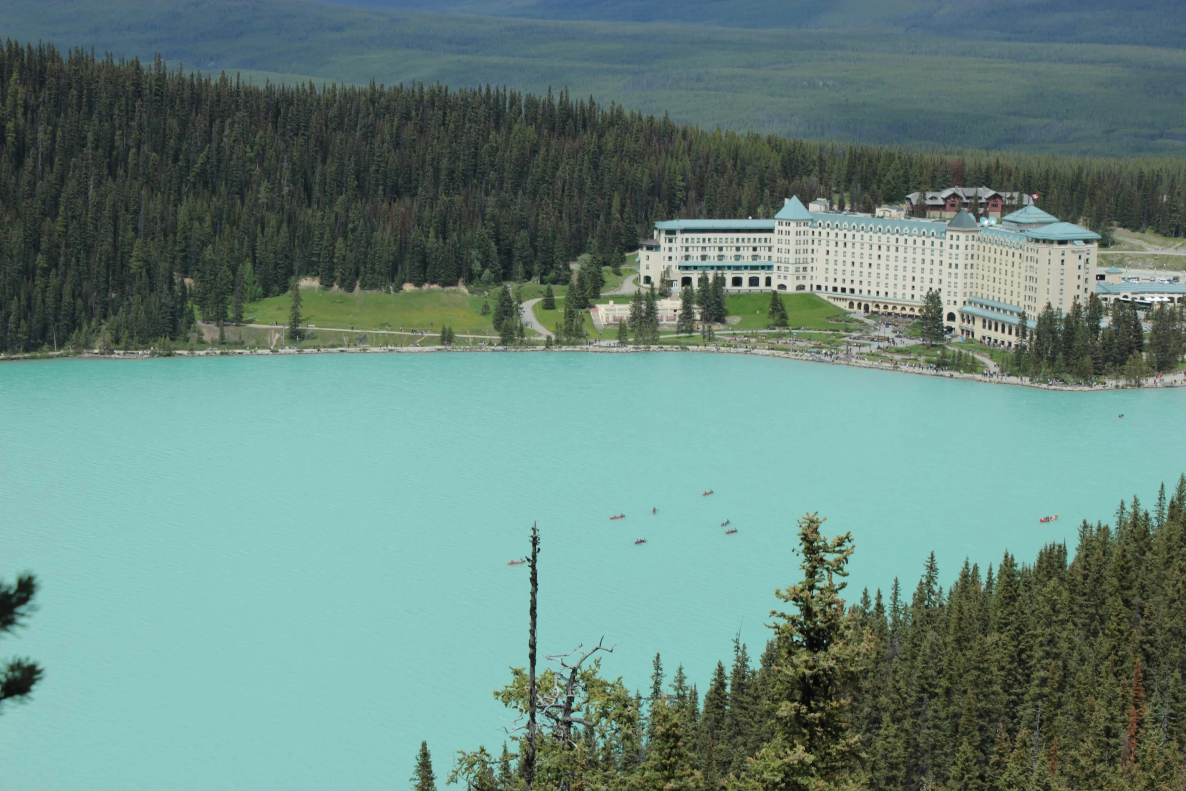 a large white building is next to the water