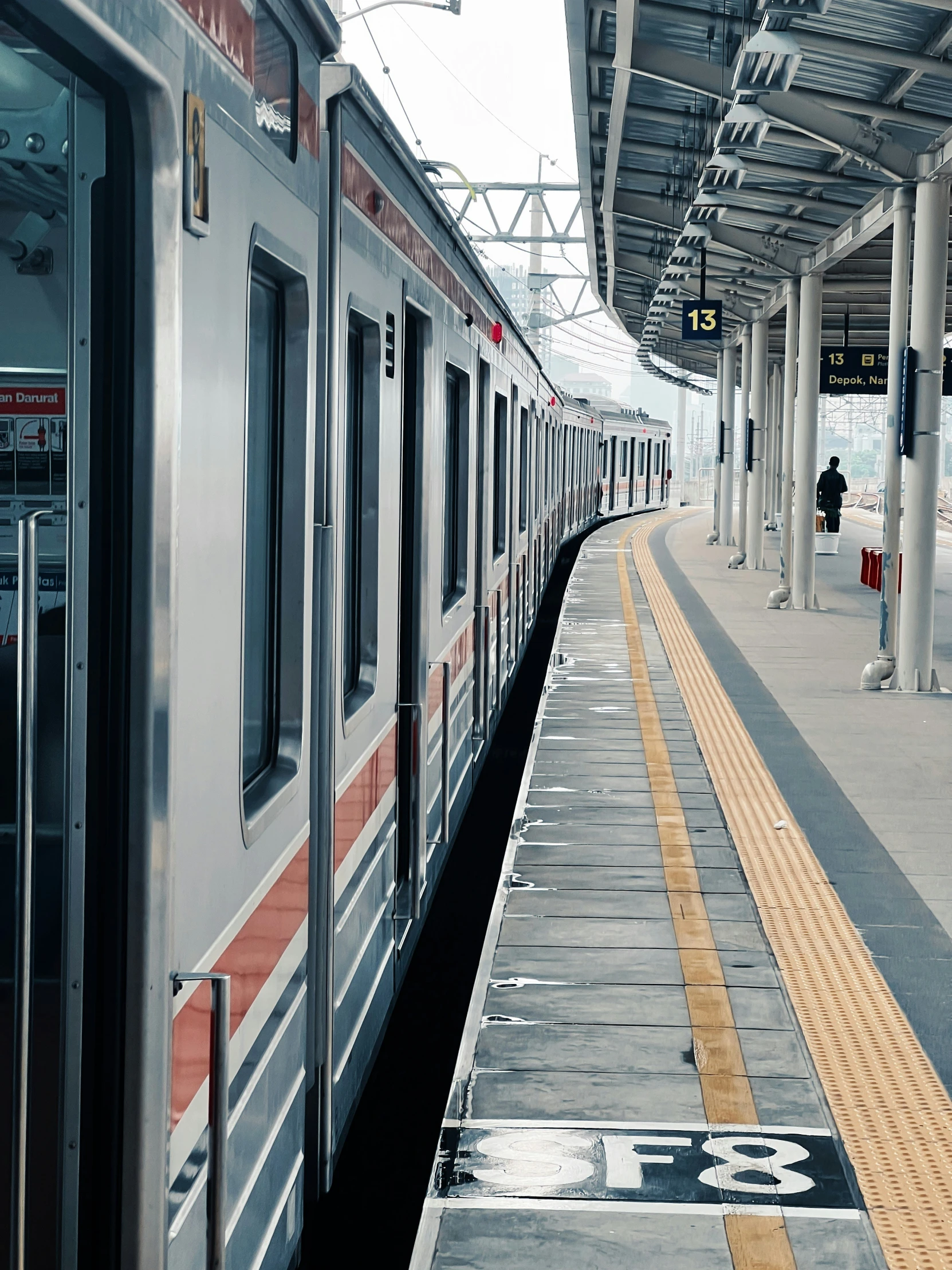 a train stopped on the platform of an airport