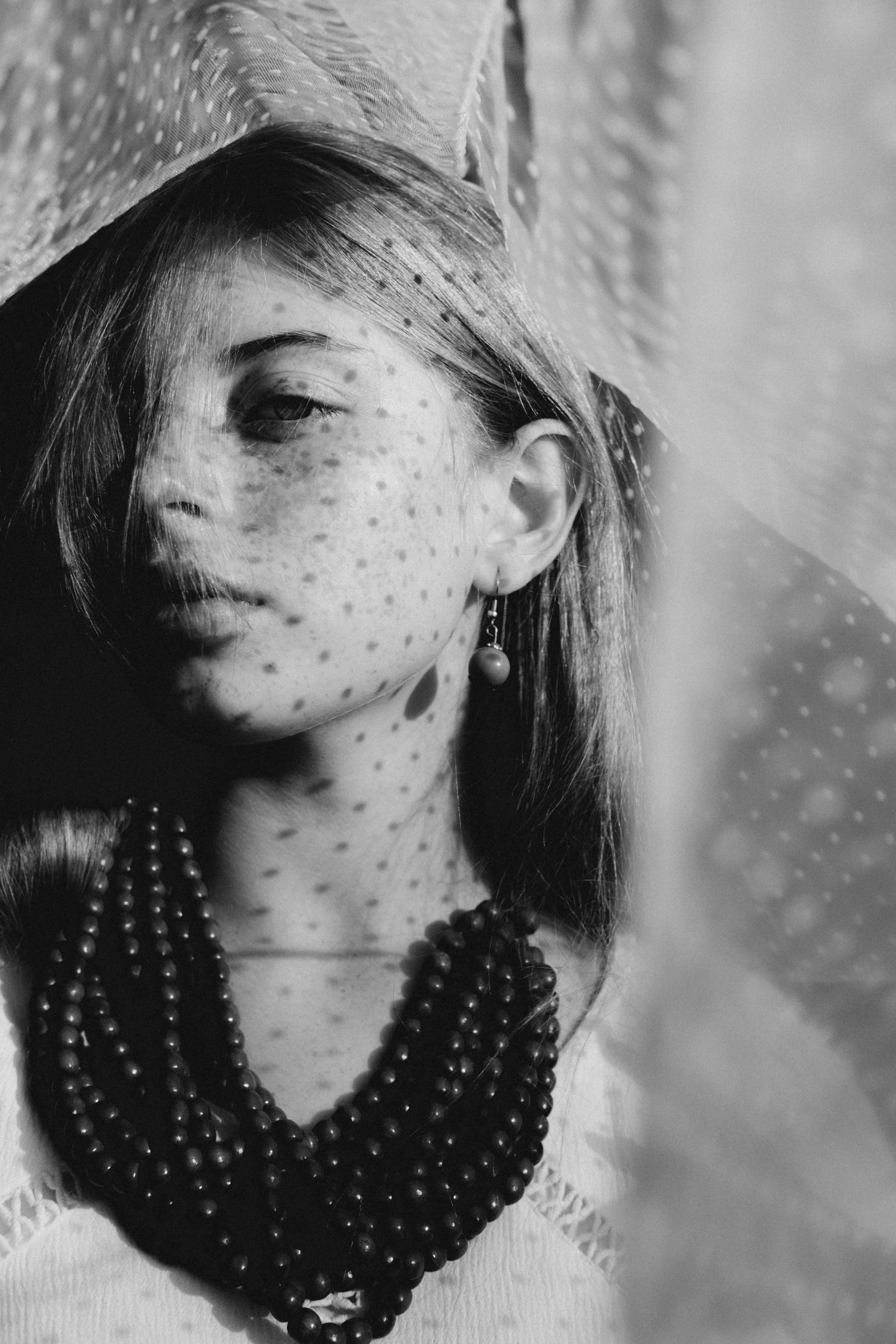 a lady with a necklace hanging from her neck