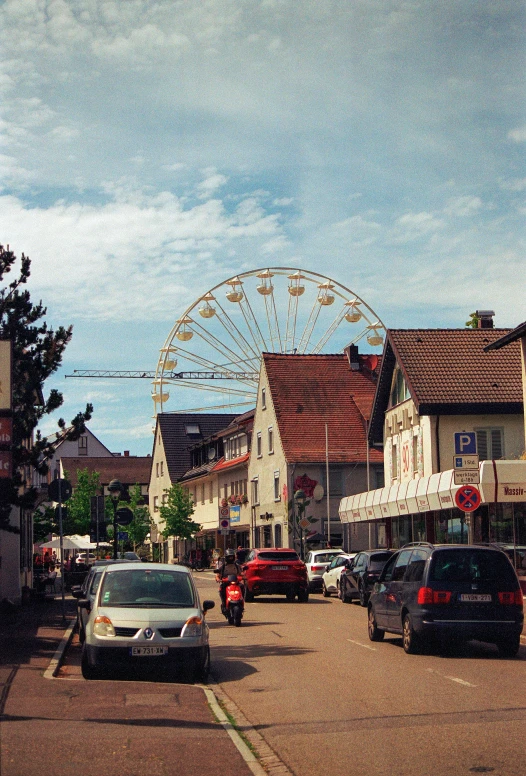 an amut park ride is in the distance between buildings