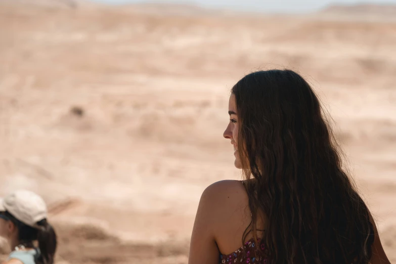 a woman with long hair looking back on her