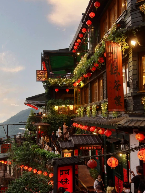 an outdoor venue with lanterns and chinese decorations on the side of a building