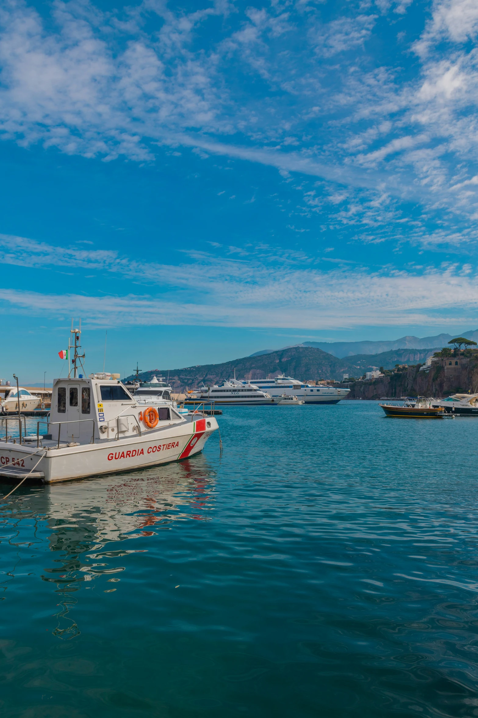 small fishing boat in the water with other boats