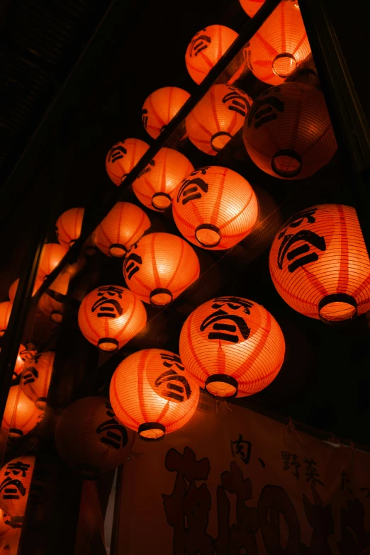 there are many oriental lanterns hanging down