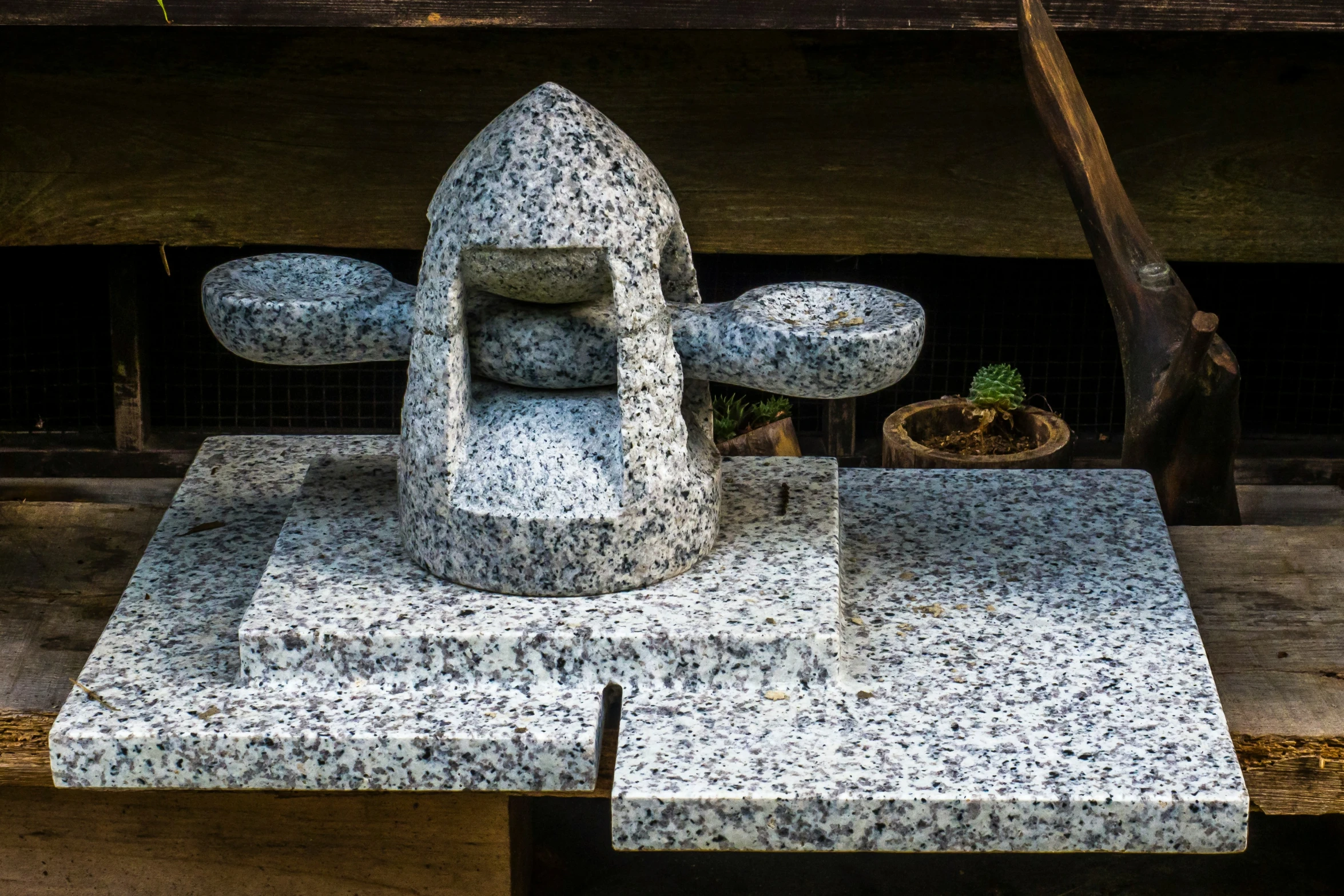 a cement statue in the shape of an airplane