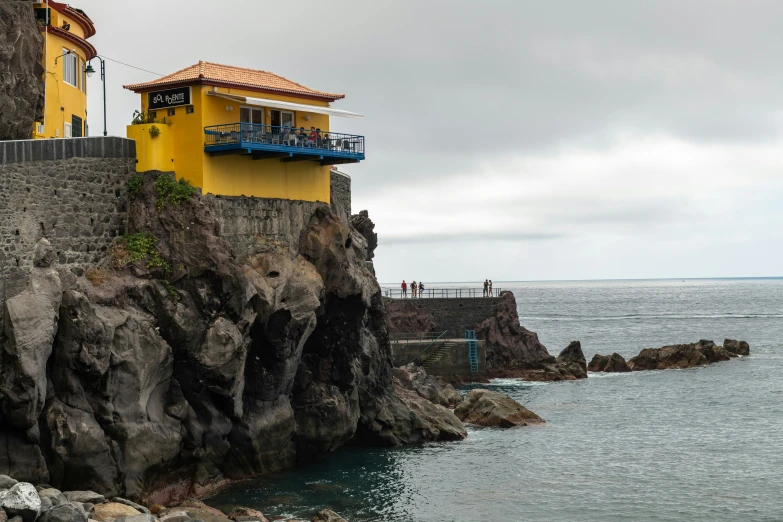 the beach area has large cliffs along with houses