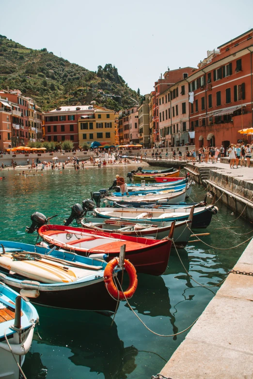 rowboats lined up next to a stone dock