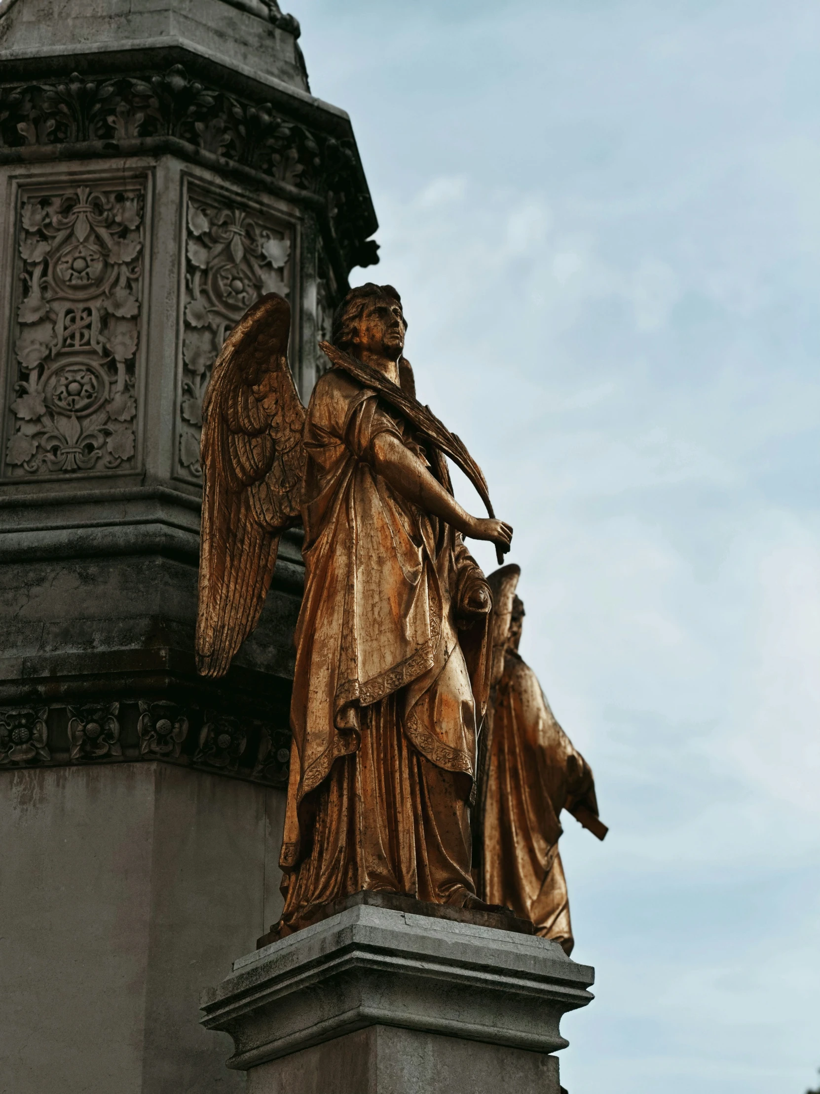 an angel on a statue on top of a building