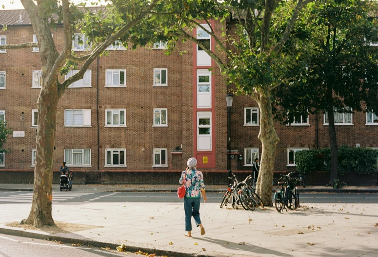 a person walking next to a tall building