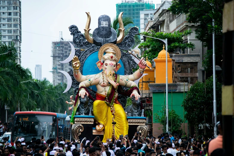 the giant statue of hindu god in the street during festival