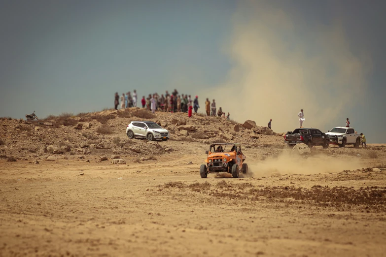 a four wheeled vehicle riding through the sand