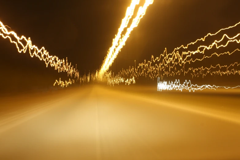 lights of car traveling down the road at night