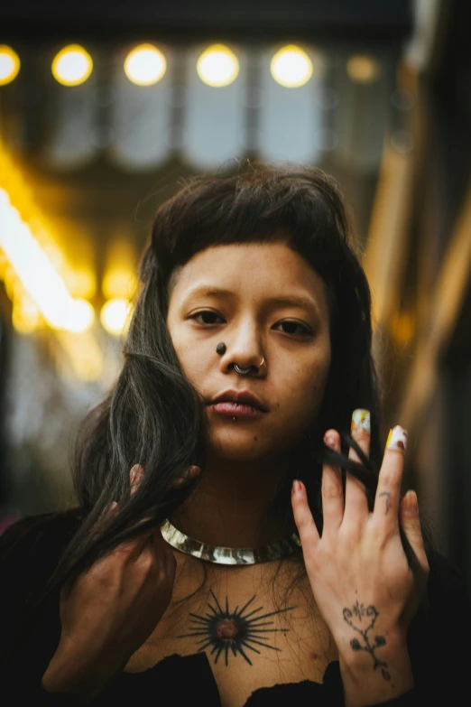 a person with long hair and a necklace on her neck