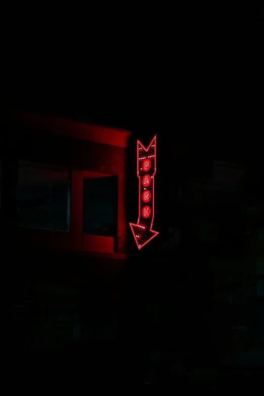 an old building lit up with neon letters