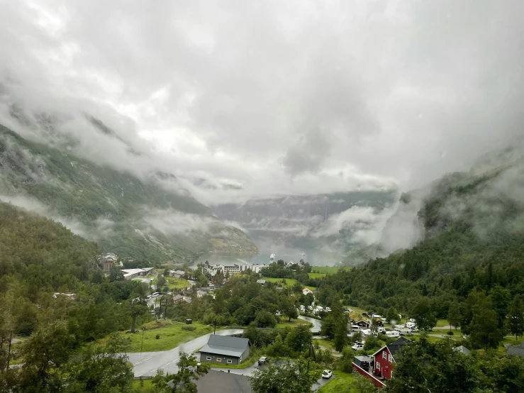 a scenic scene of a valley with a green hillside