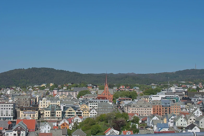 a city has buildings with the mountains in the background