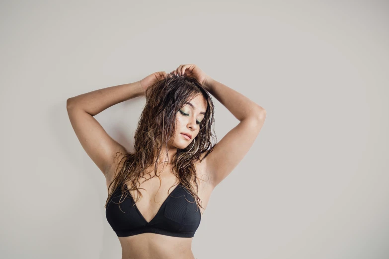 a woman in black bikini standing on the floor