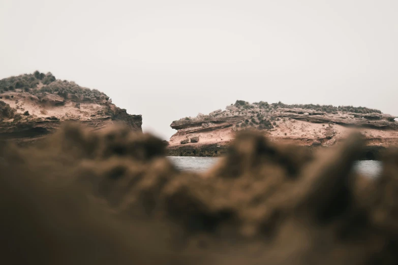 some rocks in a beach with lots of water