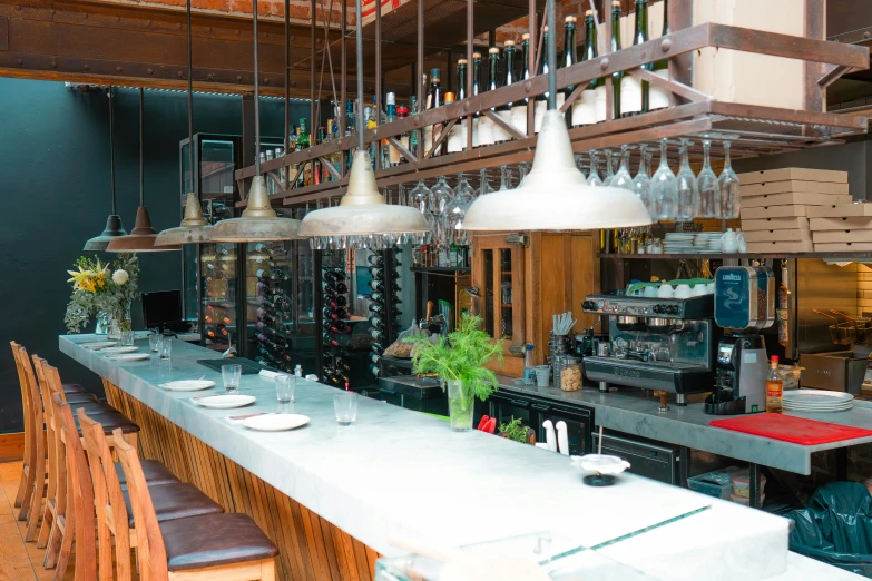 a bar with glassware hanging from the ceiling