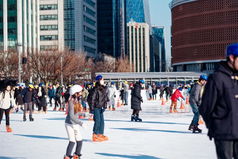 an outdoor group of people on ice skates