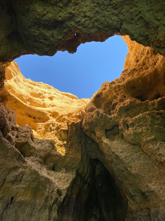 a view through an opening in the cliff wall