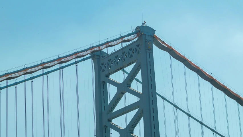 a bird is perched on top of the bridge