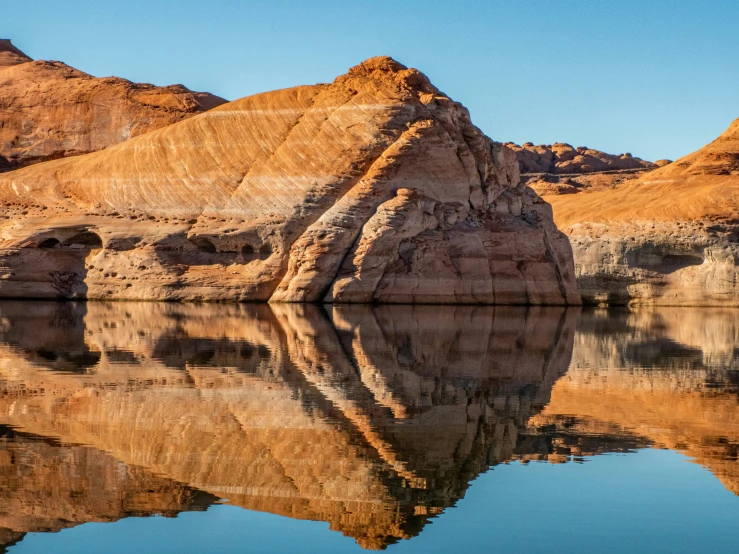 a rock formation and a reflection in the water