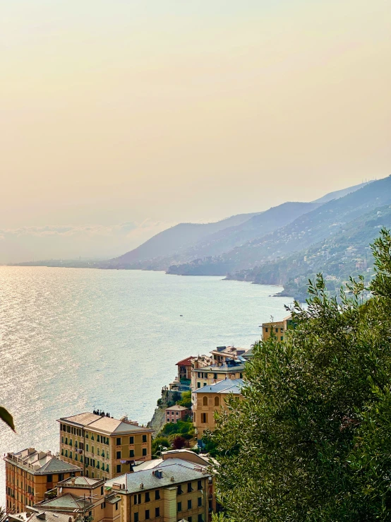 a town and the sea at dusk on a mountain top