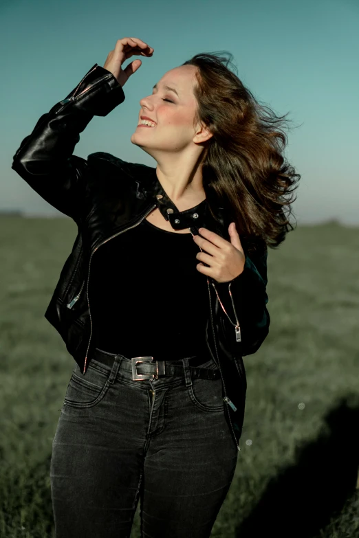 a girl in a field is looking away from the camera