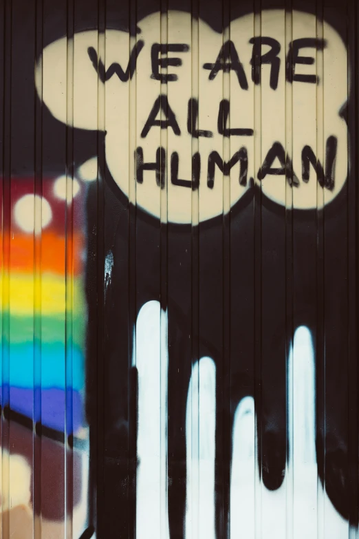 the graffiti on the door says we are all human