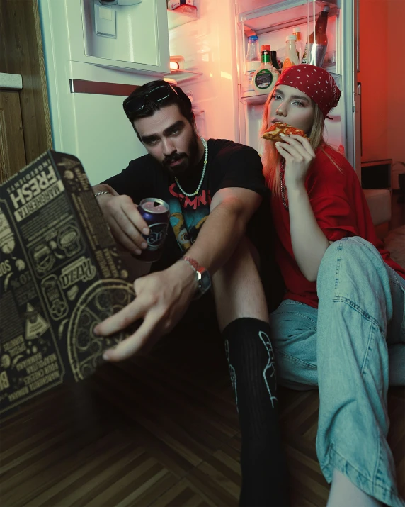 a man and woman with fake food sitting in front of a book