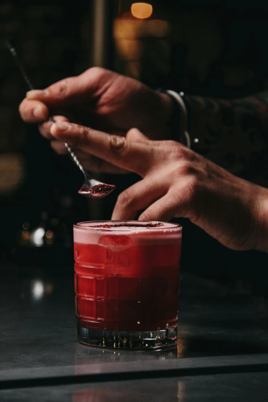 a person with their hand on a glass