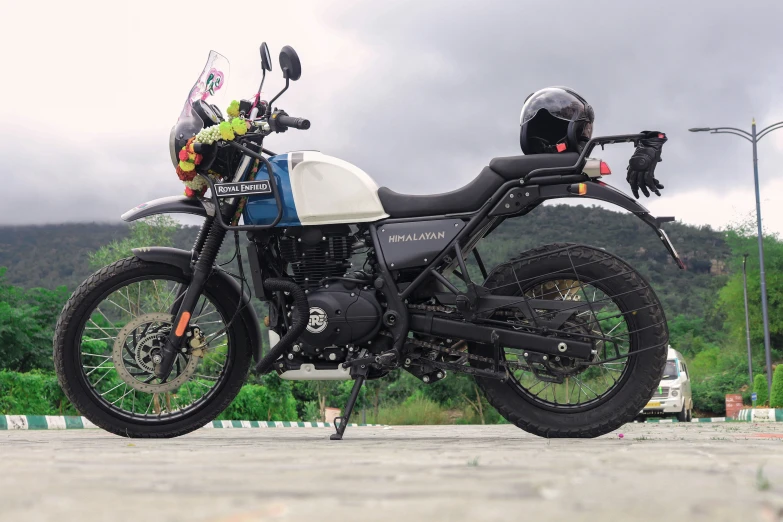 the motorcycle is parked on the cement beside some road