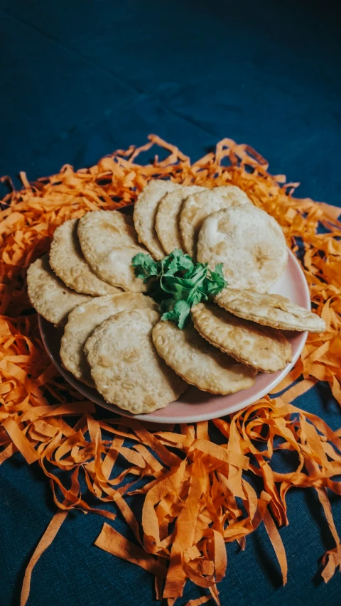 a plate of ers are sitting on orange shredded papers