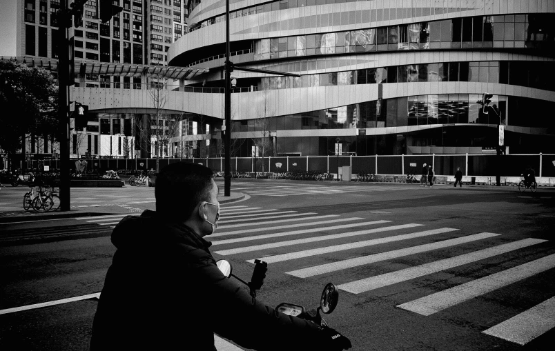 a man standing with a suitcase on the street