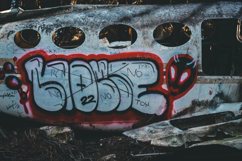 some graffiti on the side of a metal tank