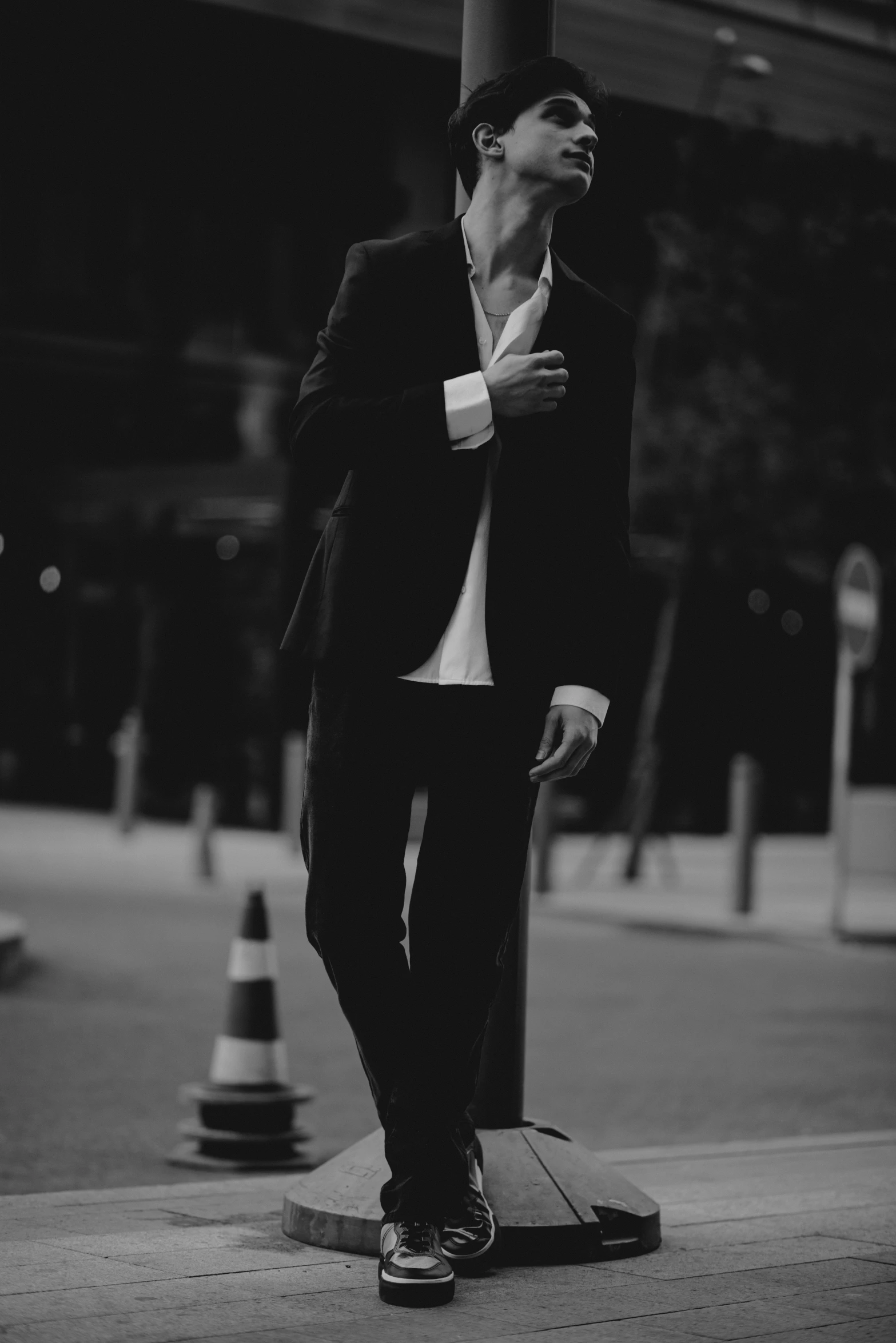 a man in a suit and tie standing on a skateboard