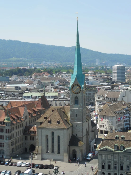 a tall church spire is surrounded by buildings