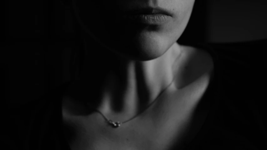 black and white po of woman with large necklace