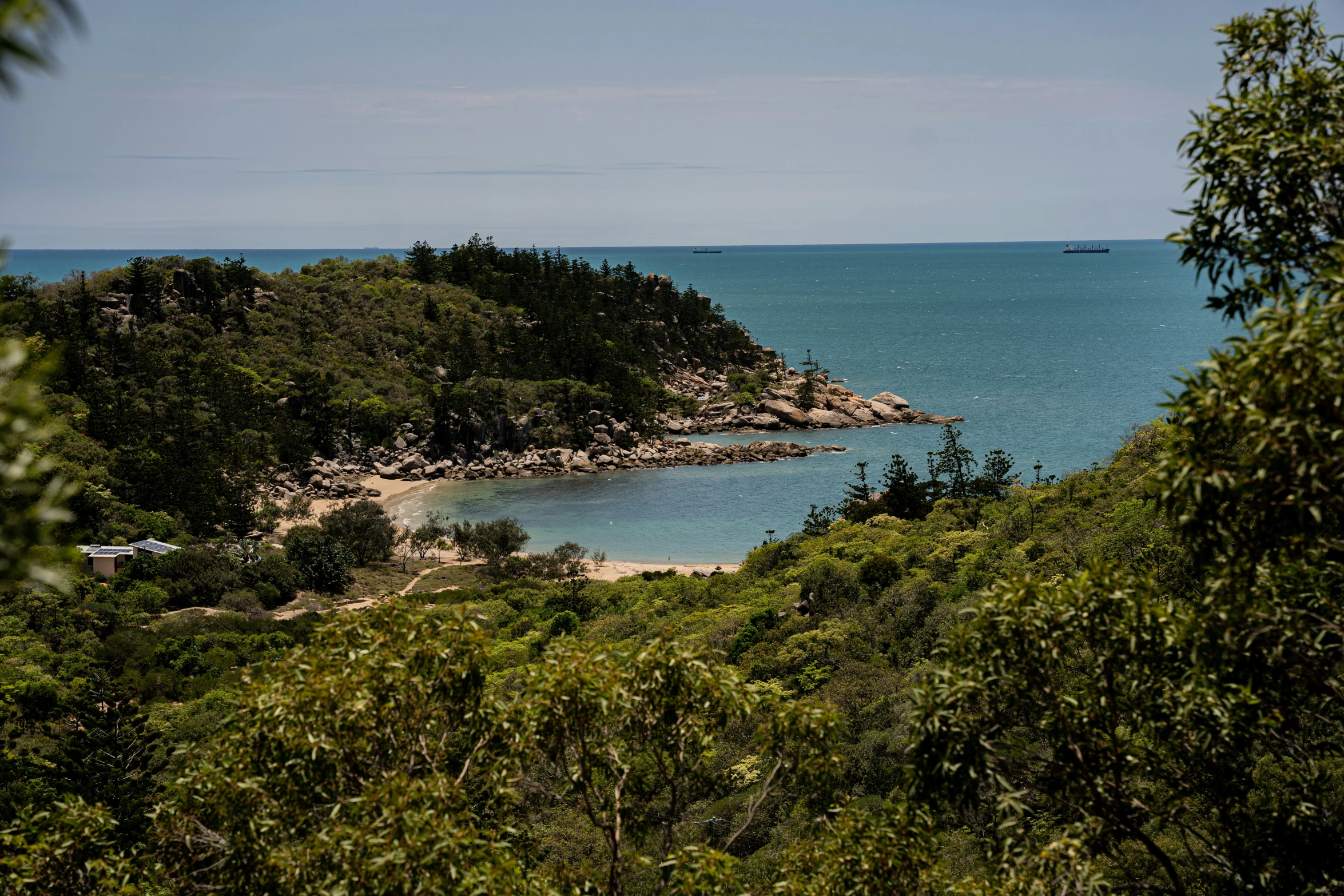 a lake surrounded by some trees near a beach