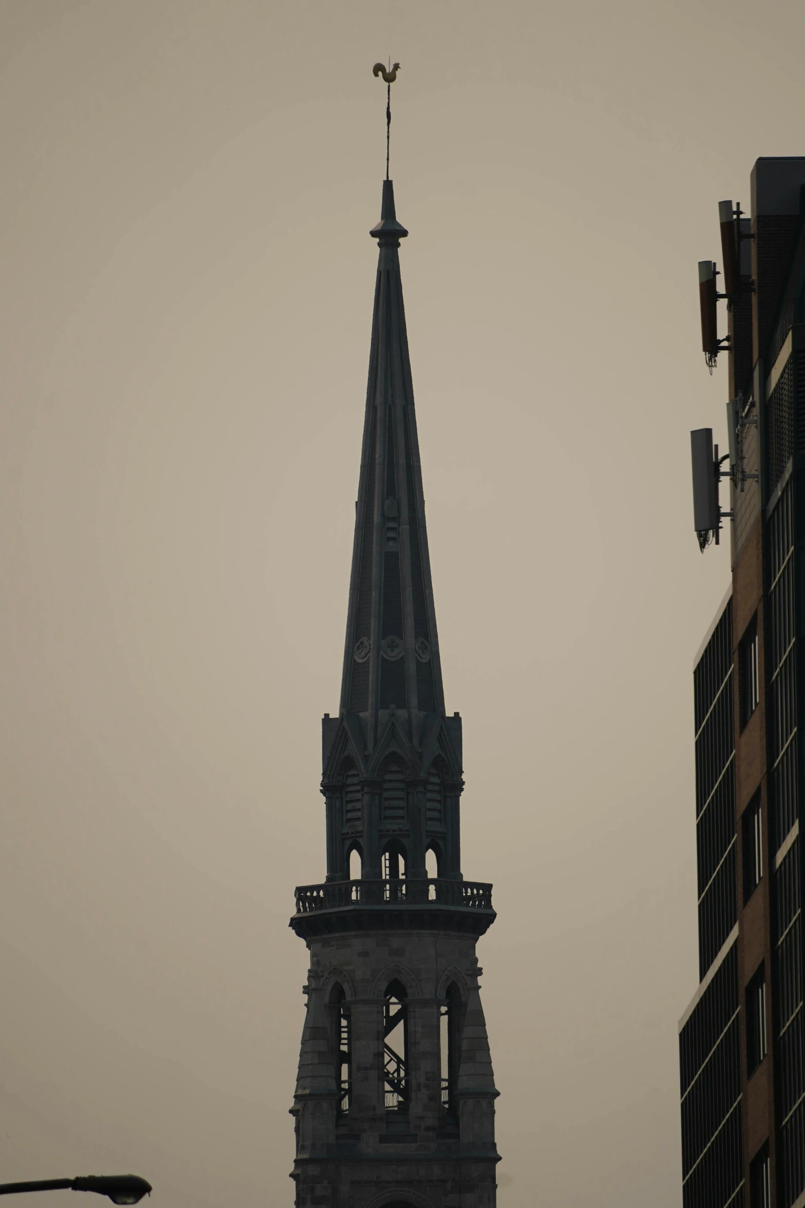 an old stone church steeple with a light on at the top