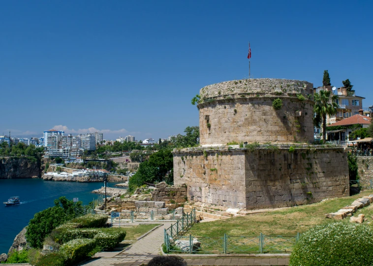 a large rock tower sitting on top of a hill