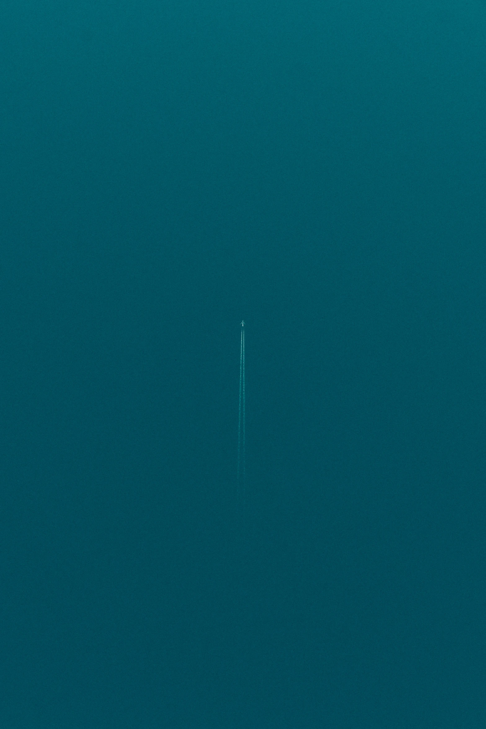 this is a picture of a lone jet airplane in the blue water