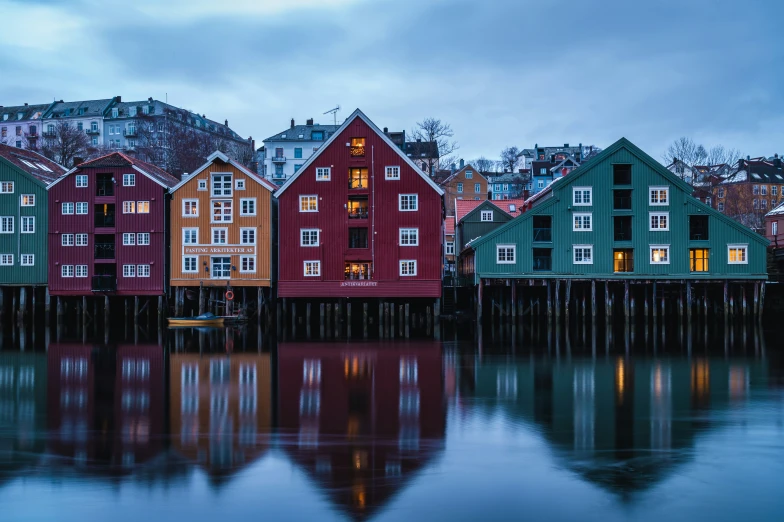 a colorful row of houses on a small pier