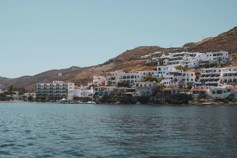 a view of a coastline with houses along the shoreline