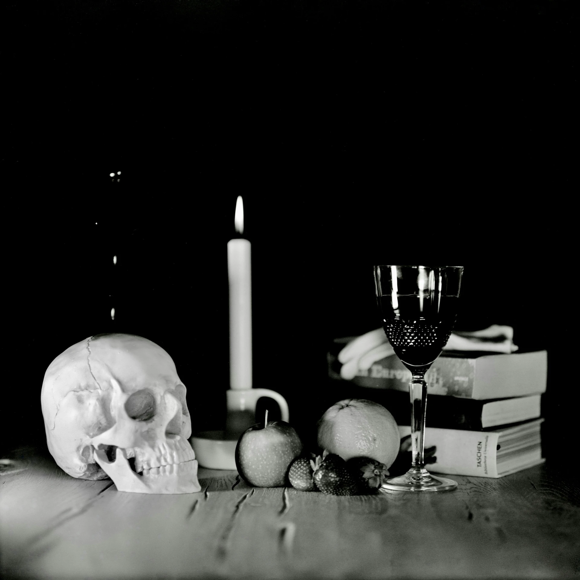 a table topped with books and a candle