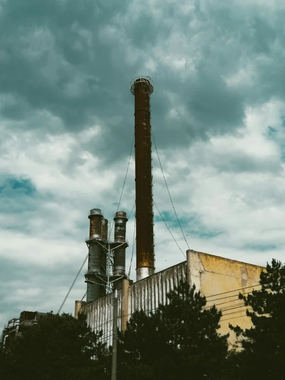 this is an old factory with a stack of smoke stacks